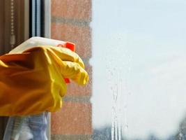 detergent jet from spray bottle on window glass photo