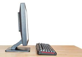 side view computer display and keyboard on table photo