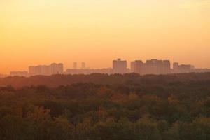 dark orange early sunrise over houses and park photo