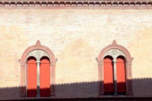 windows in wall of medieval palazzo photo