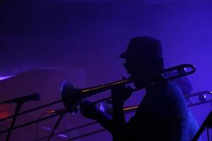 silueta de un músico de jazz en un club con poca luz foto