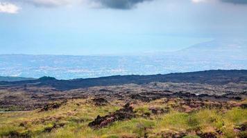 overgrown slope of Mount Etna and Ionian Sea coast photo