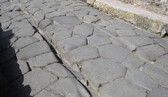 Carved tracks in a road in the Roman city of Pompeii photo