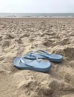 Pair of flip flops at the beach photo