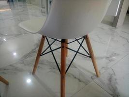 modern white chair on marble floor photo