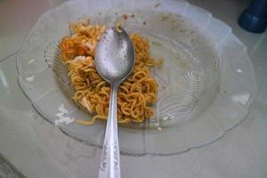 brown curly noodles on a clear glass plate photo