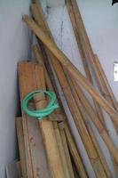 pile of used boards and bamboo in the corner of the room photo