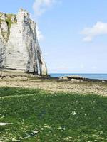 cliff on english channel beach during low tide photo