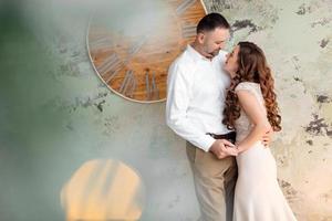 Photo shoot in the studio of a young married couple. A guy with a girl in festive clothes are celebrating Christmas. New Year's love story. The New Year Concept. valentine's day