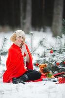 Cute girls have fun in the frozen park. Woman in a knitted sweater.the girl's hands froze photo