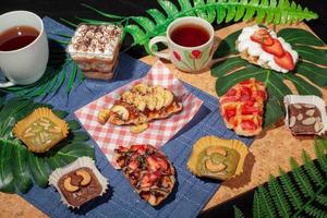 Dessert Table top view on wooden floor decorated with leaves. photo