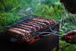 Lulya kebab from meat are prepared in the grill. Shish kebab in the grill. photo