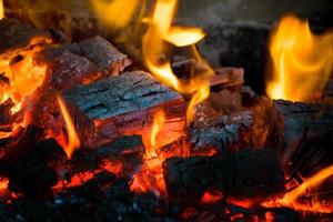 Crest of flame on burning wood in fireplace. Burning firewood in a Russian stove. photo