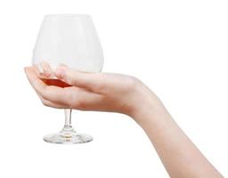 glass with brandy in hand isolated photo
