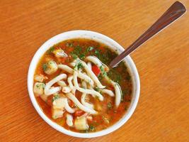 top view of laghman soup in white bowl photo