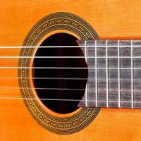 fretboard and sound hole of acoustic guitar photo