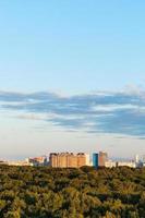 blue sky over city and green forest in summer photo