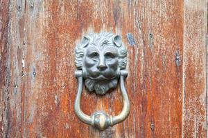 ion head shaped door handle on shabby door photo