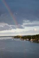 rainbow in rain during sunshine photo