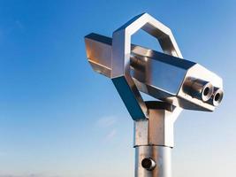 stationary observation binoculars and blue sky photo