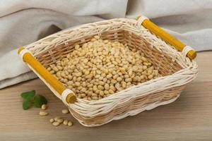 Cedar nut in a basket on wooden background photo