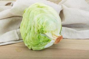 iceberg salad on wooden background photo