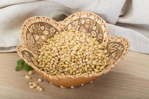 Cedar nut in a basket on wooden background photo