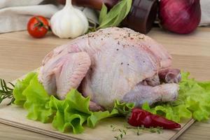 Quail on wooden board and wooden background photo