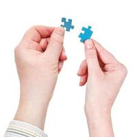 male and female hands with little puzzle pieces photo