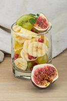 Fruit salad on wooden background photo