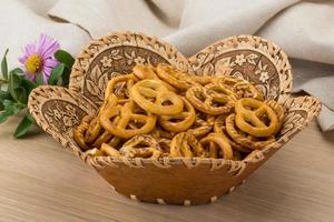 Pretzel in a basket on wooden background photo