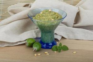 Feijoa jam in a bowl on wooden background photo