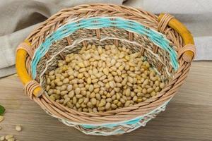 Cedar nut in a basket on wooden background photo