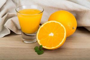 Orange juice on wooden background photo