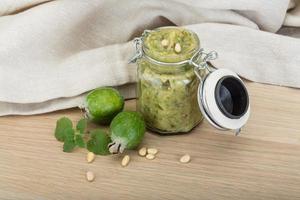 Feijoa jam on wooden background photo