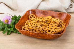 Pretzel in a bowl on wooden background photo