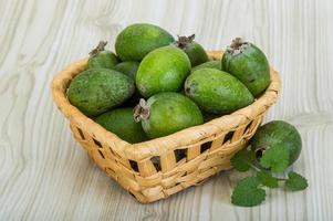 Feijoa in a basket on wooden background photo