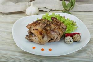 Quail grilled on the plate and wooden background photo