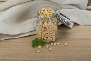 Cedar nut on wooden background photo