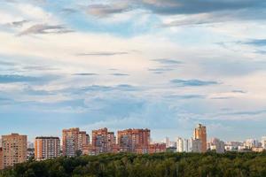 blue summer evening clouds over city photo