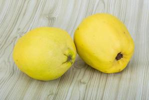 Quince on wooden background photo