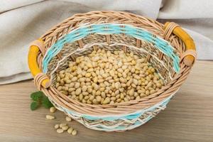 Cedar nut in a basket on wooden background photo