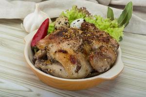 Quail grilled in a bowl on wooden background photo