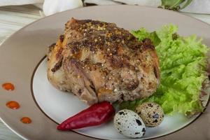 Quail grilled on the plate and wooden background photo