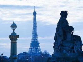 statue, column and Eiffel Tower in Paris photo