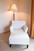 white leather chair and stand lamp photo