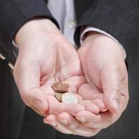 little of coins in businessman's handful photo