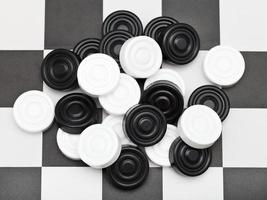 pile of draughts on checkerboard photo