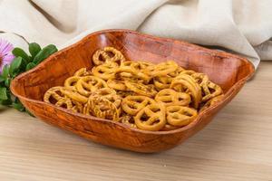 Pretzel in a bowl on wooden background photo