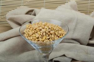 Cedar nut in a bowl on wooden background photo